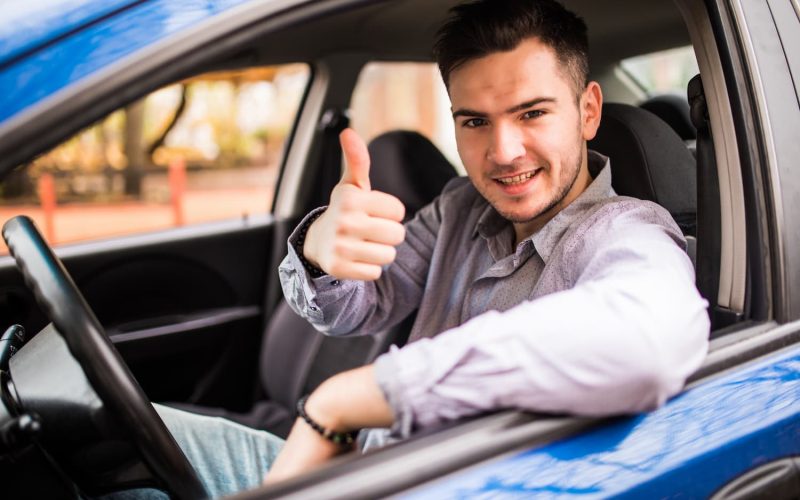 happy-smiling-man-sitting-inside-car-showing-thumbs-up-handsome-guy-excited-about-his-new-vehicle-positive-face-expression-1.jpg